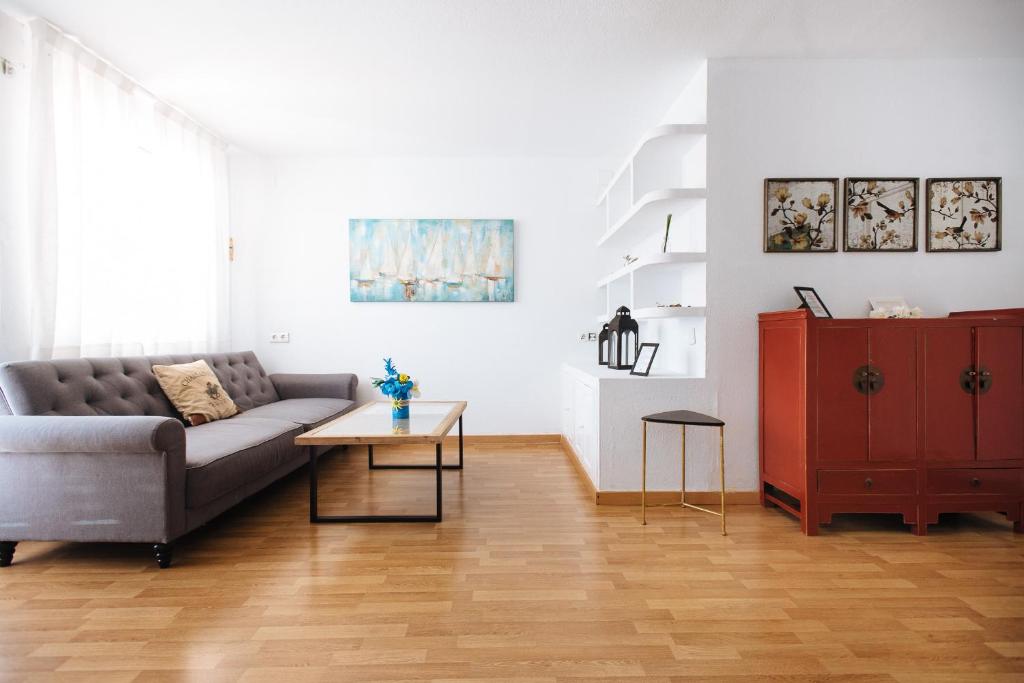 a living room with a couch and a table at HN Las Brisas in Valencina de la Concepción