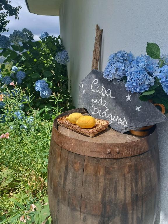 a sign on top of a barrel with a basket of cookies at Casa de Fráguas in Arouca