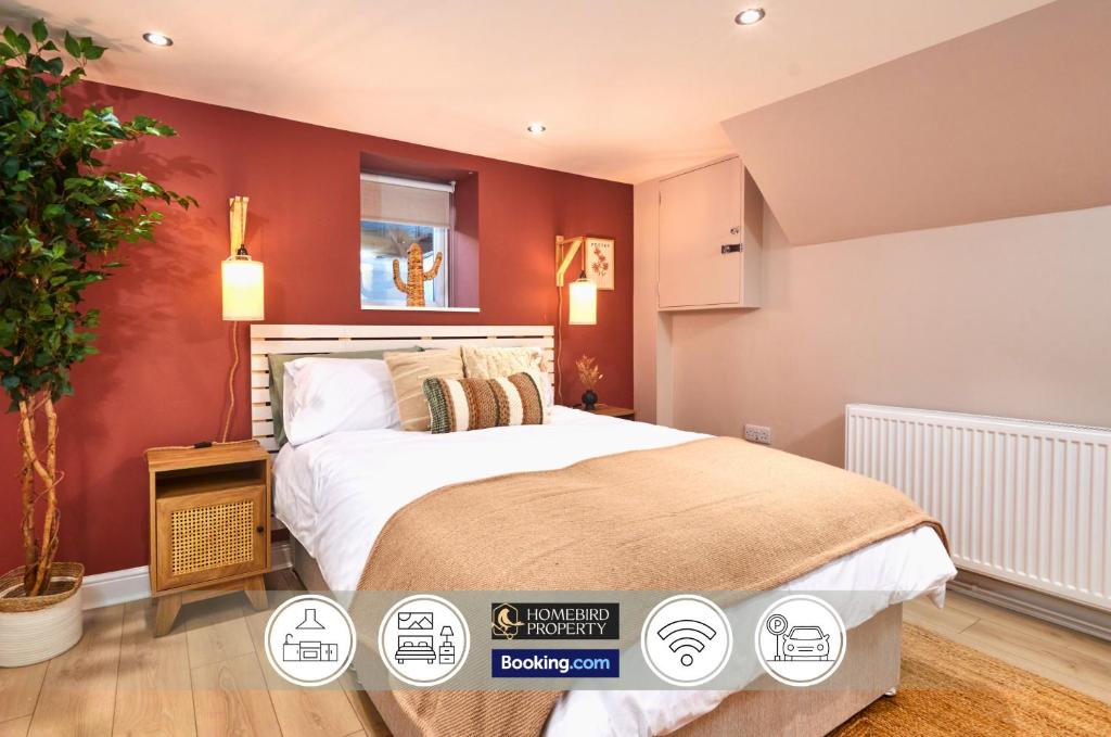 a bedroom with a large bed with red walls at Beautiful 3BDR House By Homebird Property Management Short Lets & Serviced Accommodation Leeds With Free Parking & Free WiFi in Leeds