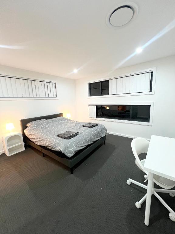 a bedroom with a bed and a table and chairs at Spacious Queen Room with Attached Bathroom - OR1 in Guildford