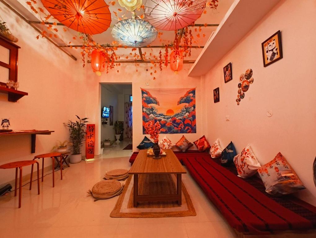 a living room with a couch and a table at Natsukashii by Ghorsirika in Guwahati
