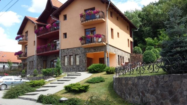 a large building with flower boxes on the balconies at Pensiunea Fortuna in Sovata