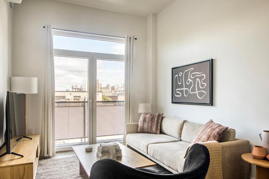 a living room with a couch and a large window at Blueground Boerum Hill rooftop nr Brooklyn Bridge NYC-1880 in Brooklyn