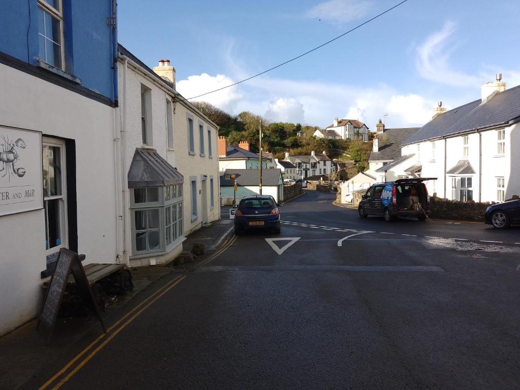a street in a small town with cars parked at Southview Wild Camping in Haverfordwest