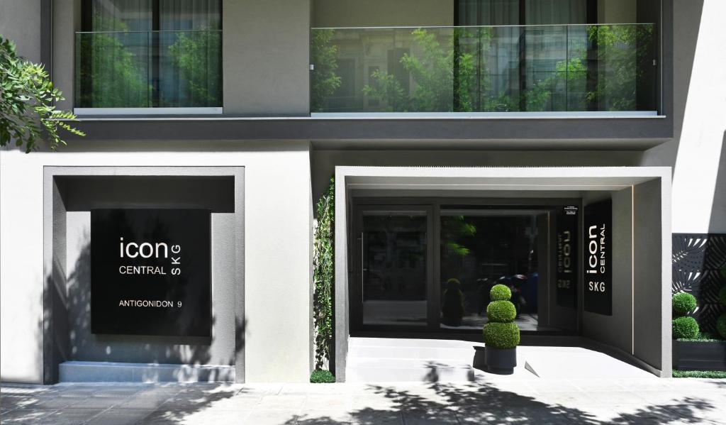 a building with two entry doors with a plant in front at Icon Central SKG in Thessaloniki