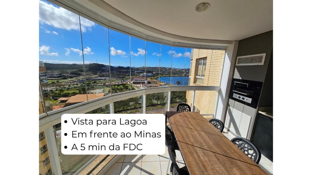 a balcony with a view of a city at Lindo AP com vista para a Lagoa dos Ingleses in Nova Lima