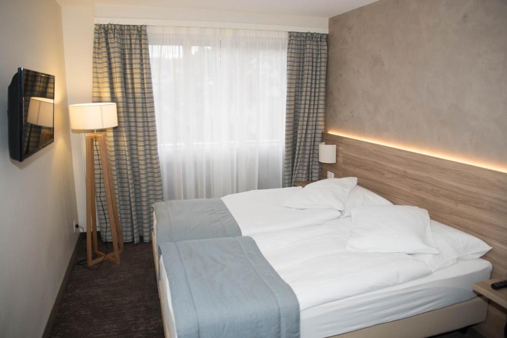 Letto o letti in una camera di Hôtel de Chailly