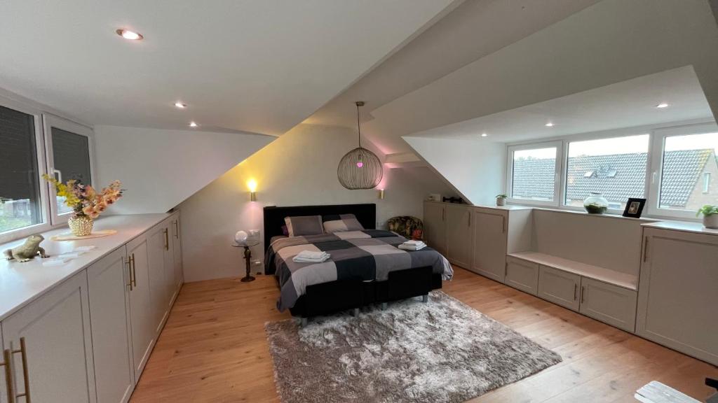 a bedroom with a bed in the middle of a room at A whole Family expat house with AC, garden, close to Efteling in Tilburg