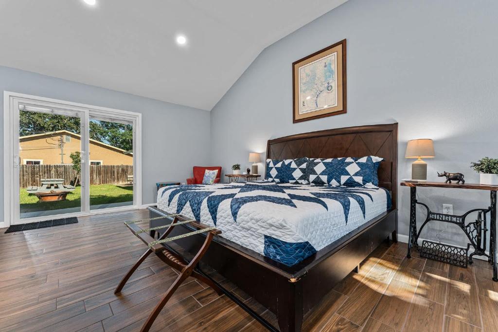 a bedroom with a bed and a large window at Walnut House - Close to Downtown Fire Pit in Fredericksburg