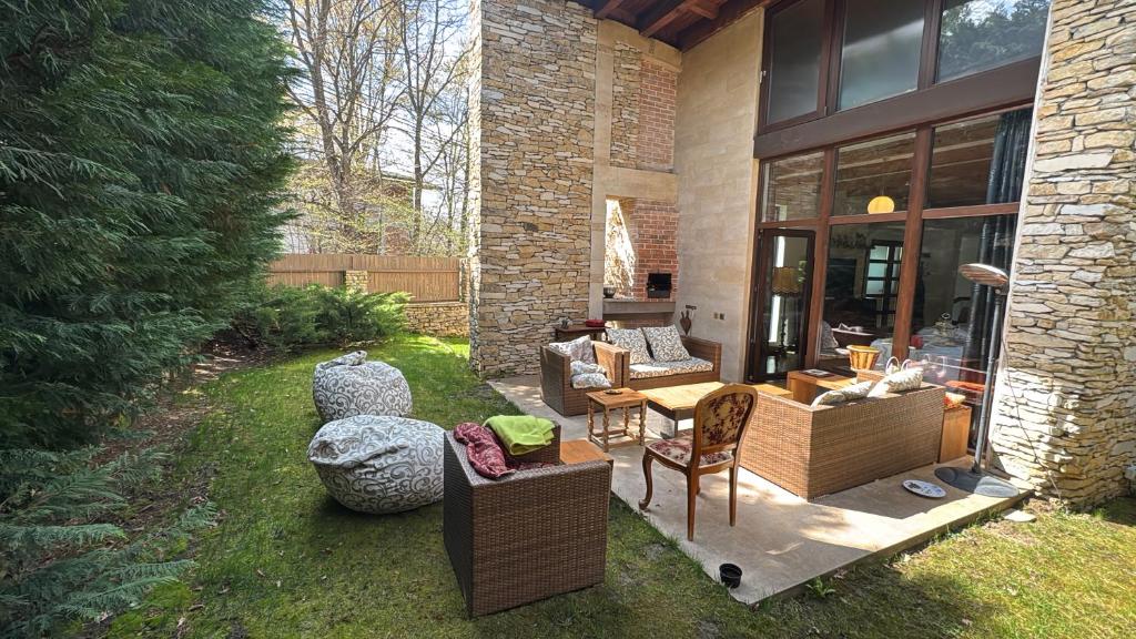 a patio with couches and chairs in a yard at Luxury Villa in Cluj-Napoca