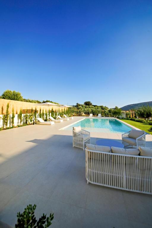 a swimming pool with lounge chairs next to a pool at ACQUA PETRA Pool Villa & Suites in Agrigento
