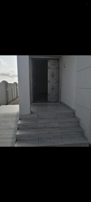 a room with a staircase leading up to a building at فيلا في صحم in Murtafa‘āt Şaḩam