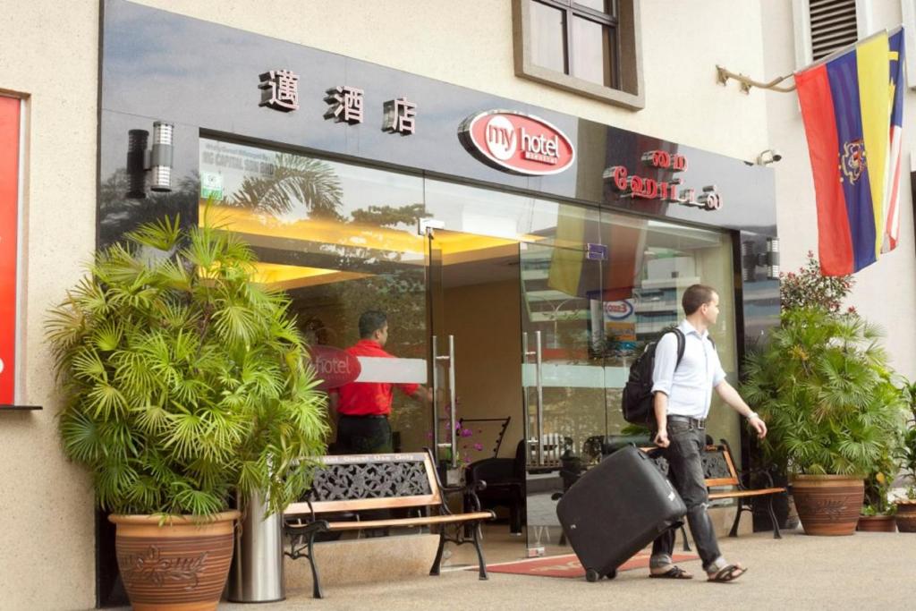two men walking in front of a fast food restaurant at My Hotel @ Sentral in Kuala Lumpur