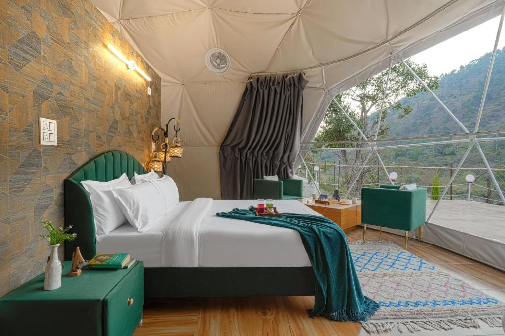 a bedroom with a bed in a tent at SaffronStays Aquadome Celeste -River Access Stay in Bhikia Sain