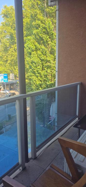 a glass balcony with a view of a building at Sanapiro + in Tbilisi City