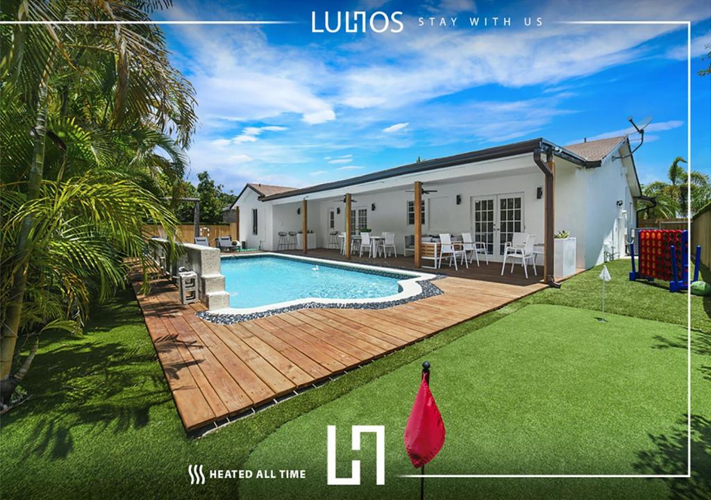 a house with a swimming pool in a yard at Miami house Heated Pool Game Room BBQ L67 in Lindgren Acres