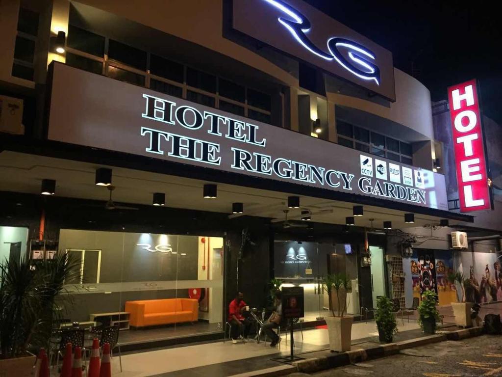 a hotel the recovery center at night with people sitting outside at The Regency Garden Hotel in Ipoh