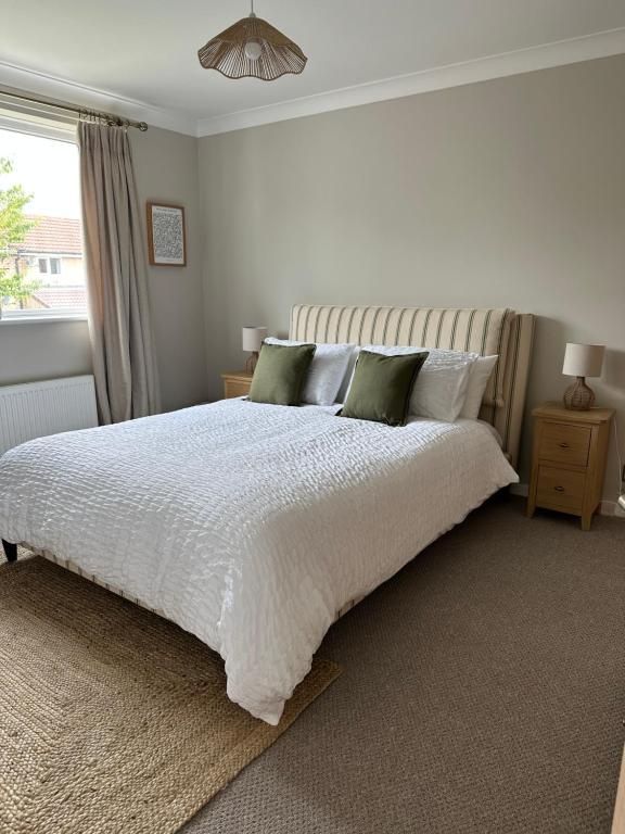 a bedroom with a white bed and a window at Cosy home for 2 in Alnwick in Alnwick