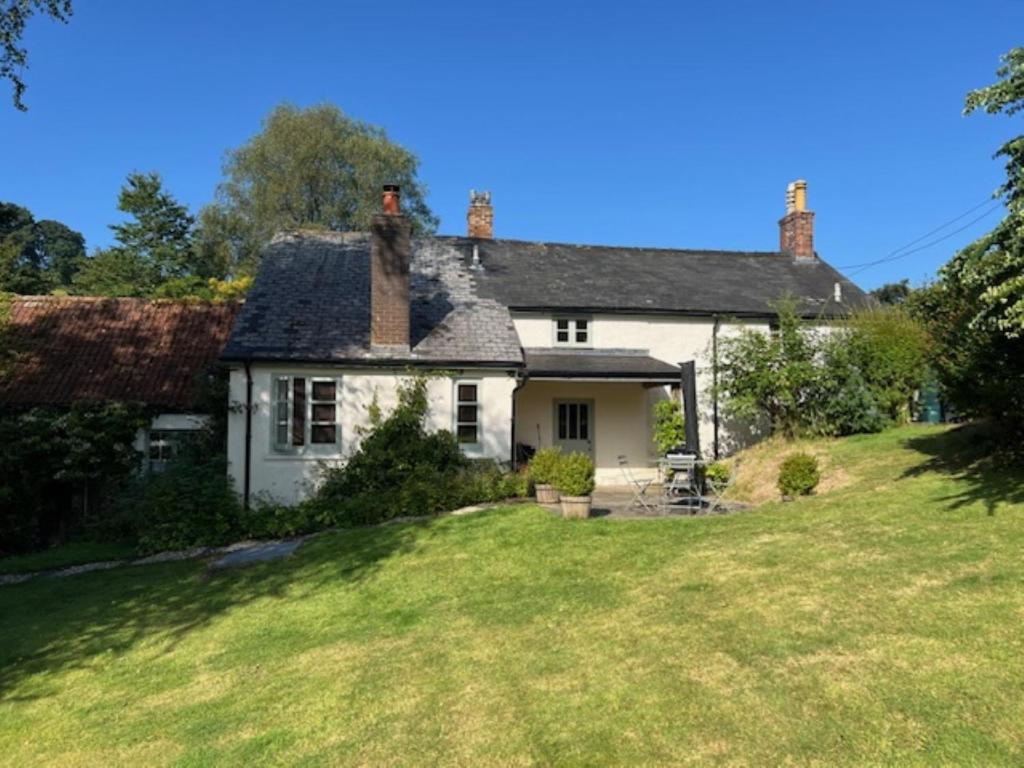 a white house on a hill with a yard at 2 Bed in Dulverton 47152 in East Anstey