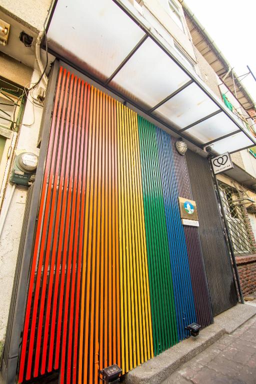 a colorful wall on the side of a building at One Heart Inn in Tainan