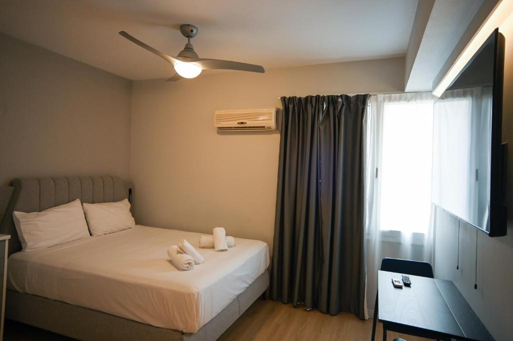 a bedroom with a bed with two towels on it at Family Suite by Zeussuites in Athens