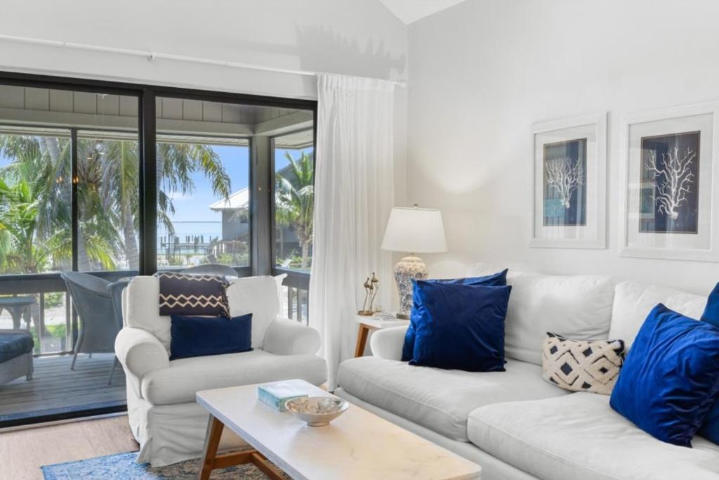 a living room with a white couch and blue pillows at Ventura Captiva 2B condo in Captiva