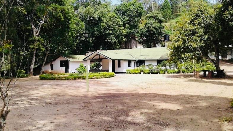 a house with a large driveway in front of it at Rosewood Bungalow in Bandarawela