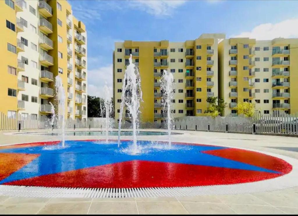 a fountain in a courtyard with buildings in the background at Aviva Sierra 1804 in Santa Marta