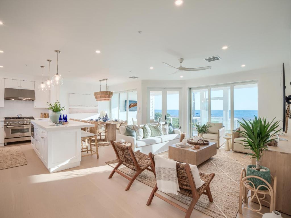 a living room with a kitchen and a dining room at Sandrift Villa in Captiva