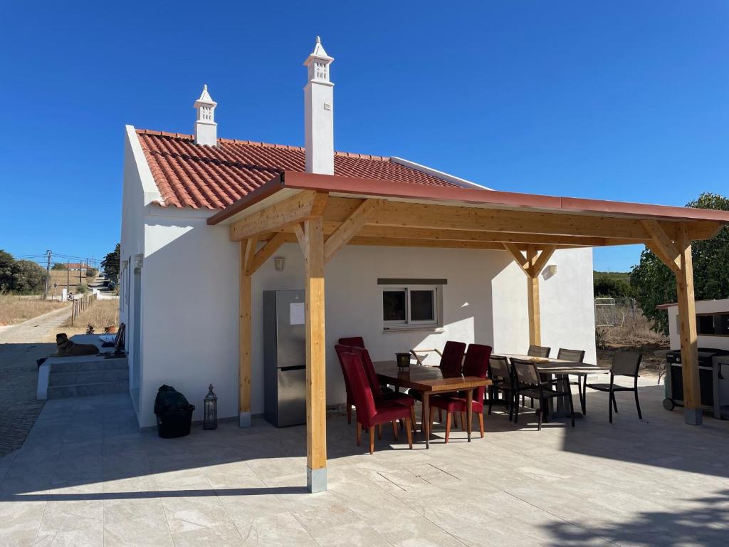 a pavilion with tables and chairs on a patio at Quinta Madrugada Burgau in Luz
