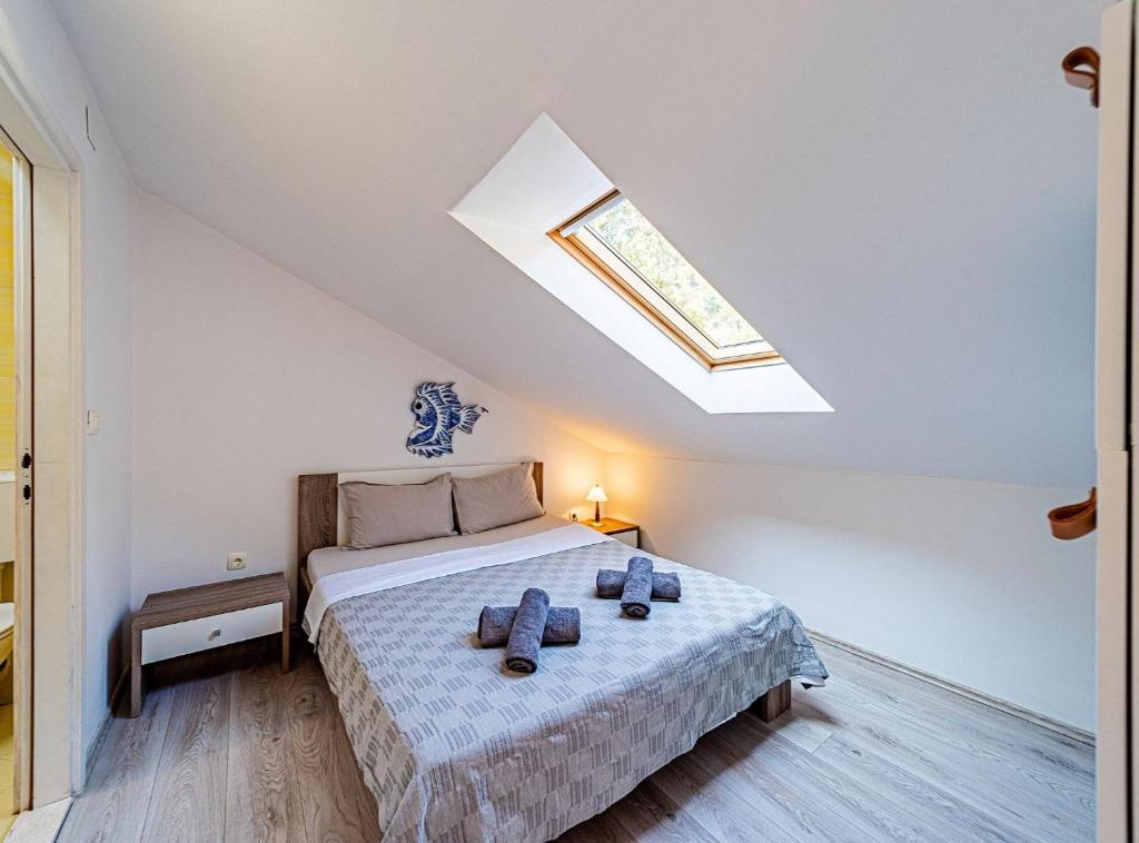 a bedroom with a bed and a skylight at Holiday Home Island Gem in Korčula