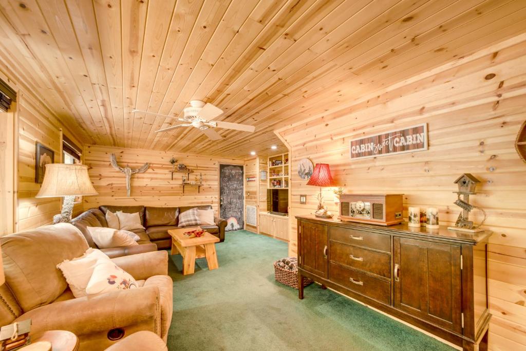 a living room with a couch and a table at Hike and Snow Play! Payson Cabin By Mogollon Rim in Kohls Ranch
