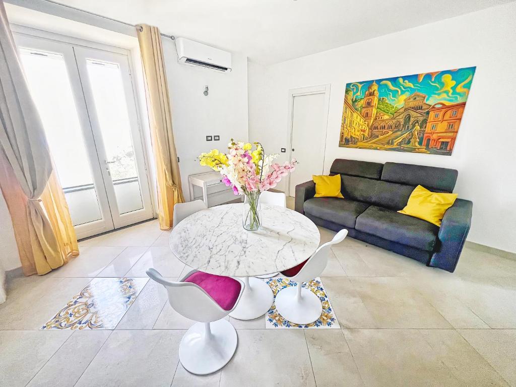 a living room with a table and a couch at Villa Mansi Amalfi Coast- Sea View Free Park in Atrani