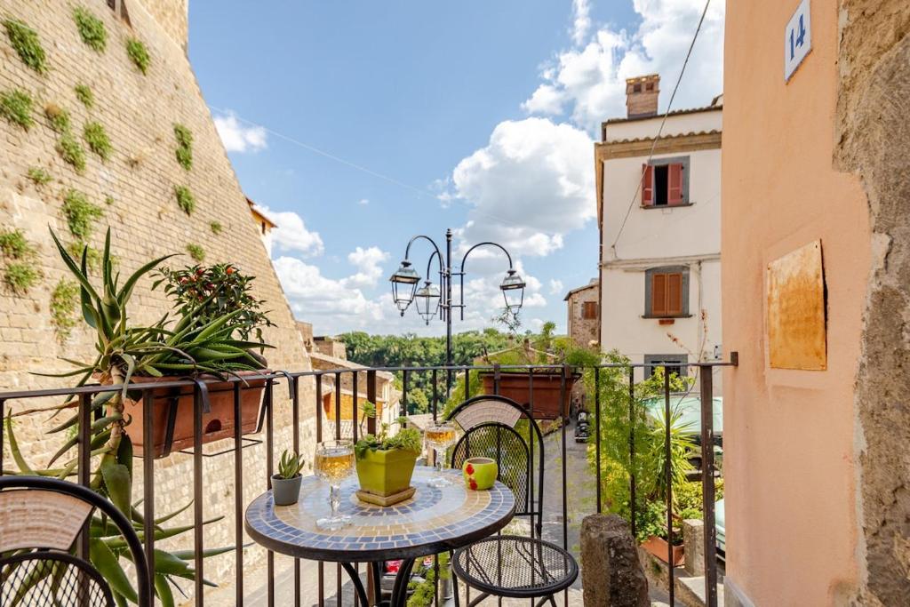 a patio with a table and chairs on a balcony at Civitella Relais in Civitella dʼAgliano