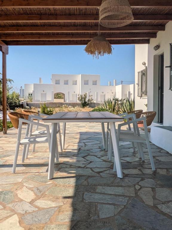 a white table and two chairs on a patio at KONAKI Private Villa in Skiros