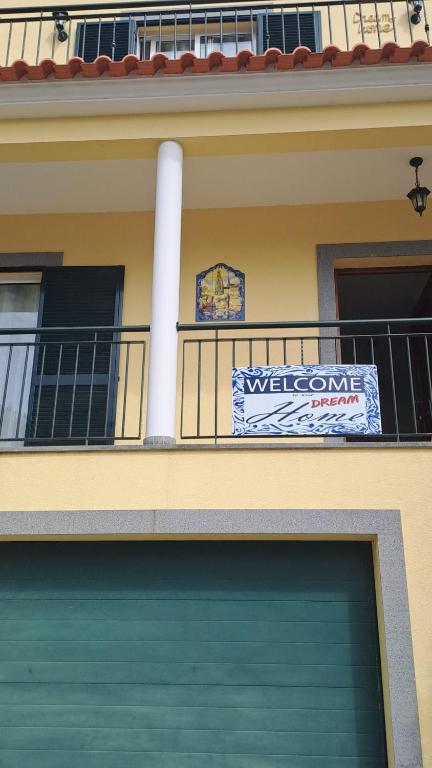 a building with a garage door and a welcome sign at Dream Home in Calheta