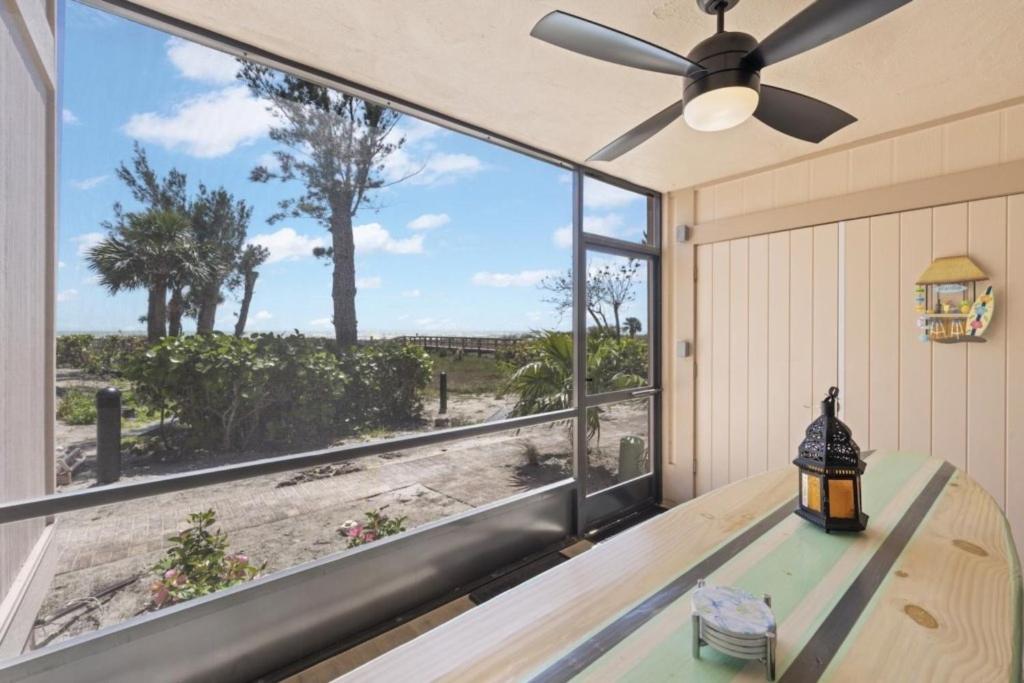 a room with a large window overlooking the beach at Coquina Beach 2C condo in Sanibel