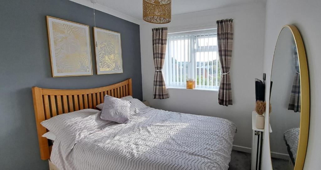 a bedroom with a bed and a surfboard in it at Self Catering Appartment 1 bedroom 2 double beds in East Cowes