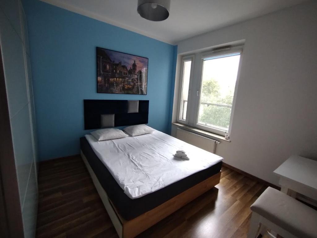 Ένα ή περισσότερα κρεβάτια σε δωμάτιο στο Apartament Osiedle Sztuk Pięknych