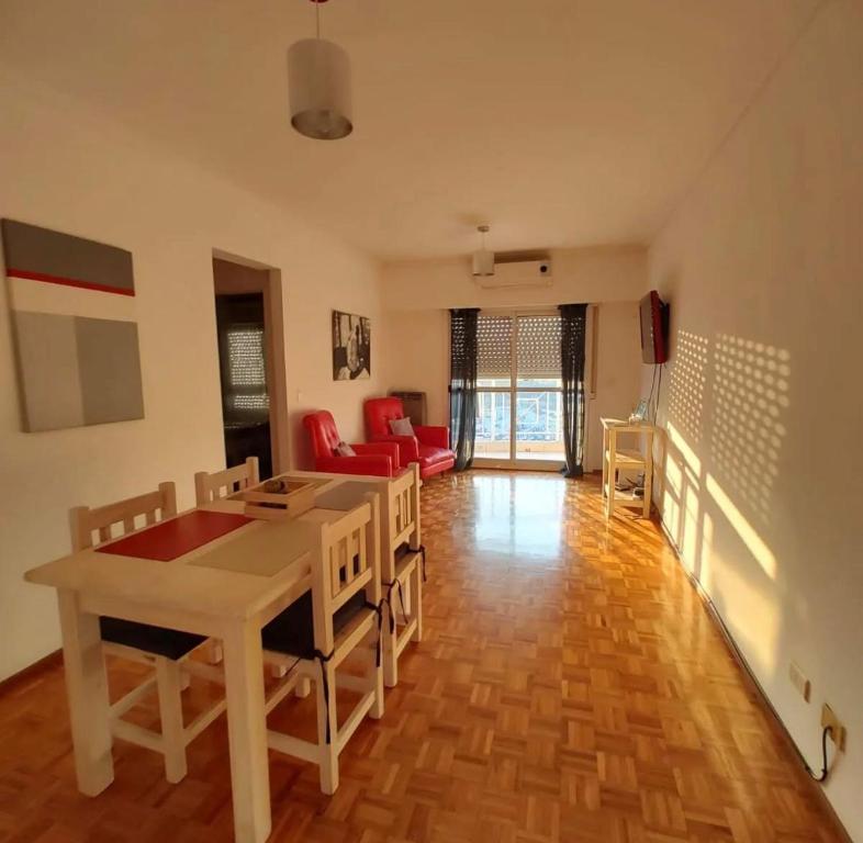 a living room with a dining room table and chairs at Tigre Centro A - piscina y seguridad 24hs - Opcional cochera paga in Tigre