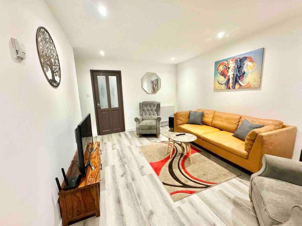 a living room with a couch and a chair at Swindon Large 3 Bedroom house Parking, Garden in Swindon