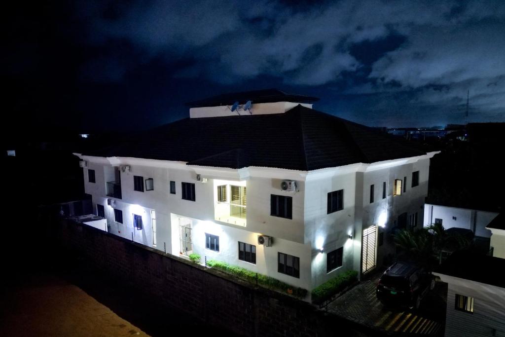 a white house with lights on top of it at night at Lekki holiday shortlet in Lekki