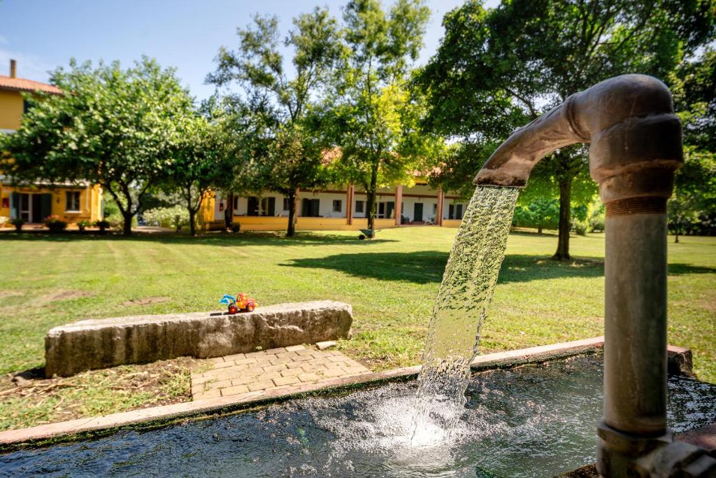 a water fountain in a park with a fire hydrant at Agriturismo Lemene in Caorle