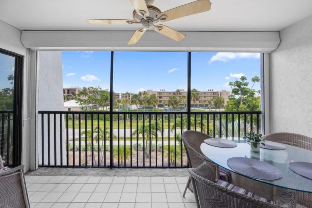 a dining room with a table and a ceiling fan at Sandpebble 3F condo in Sanibel