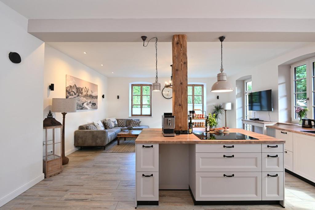 a kitchen and living room with a counter and a couch at Ferienwohnung Lämmche, EG mit eingezäuntem Garten in Polling