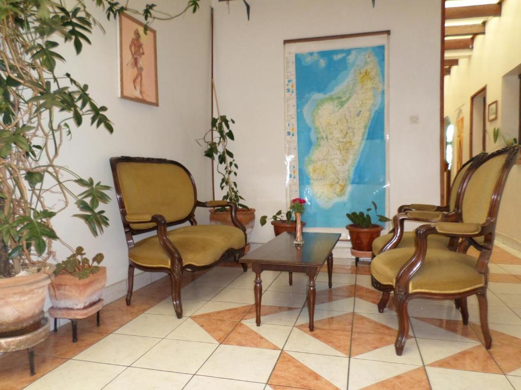 a waiting room with chairs and a map on the wall at TANA-JACARANDA in Antananarivo