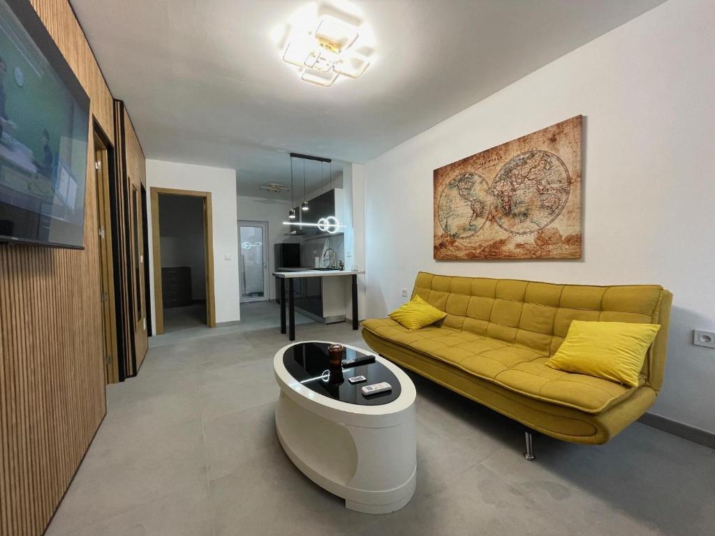 a living room with a yellow couch and a table at Flor De Sal Villa in San Pedro del Pinatar