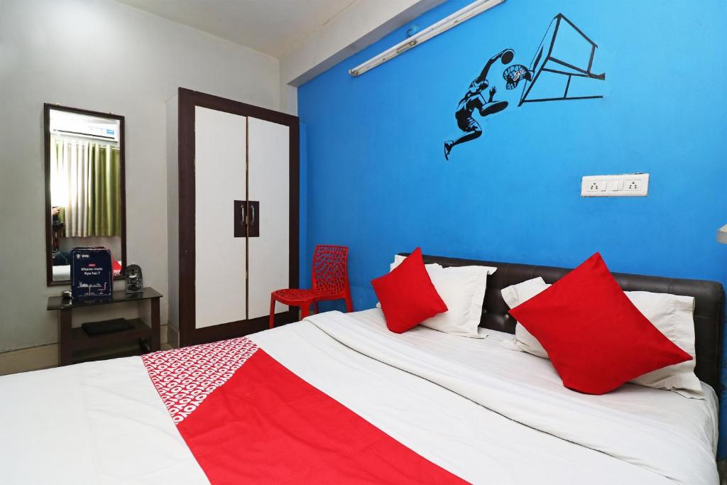 a bedroom with a bed with a hockey player on the wall at Hotel O Sher E Bengal in Durgāpur