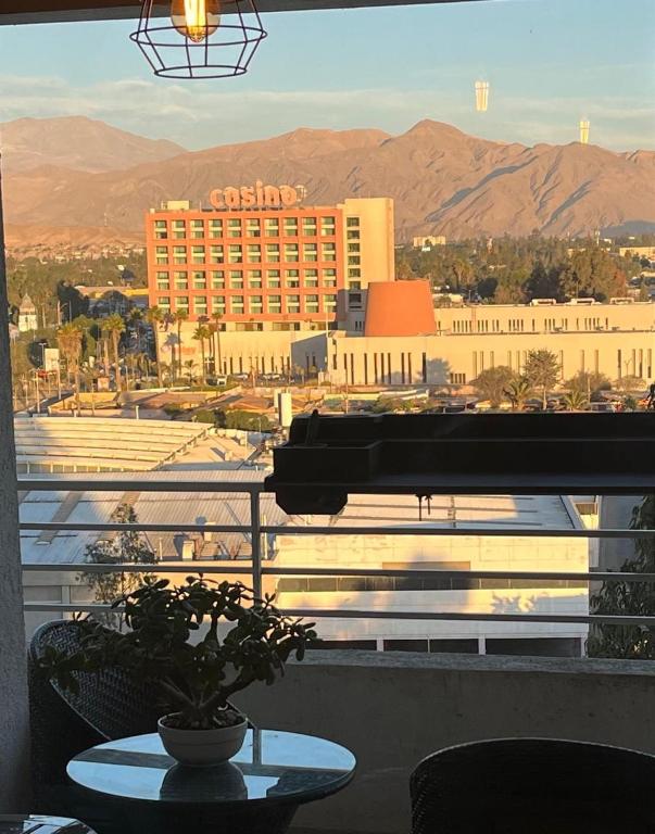 a room with a table and a view of a hotel at Departamentos Innova in Copiapó