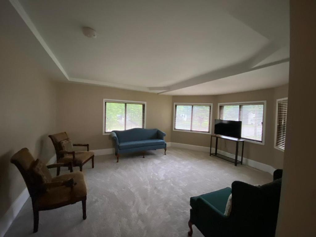 a living room with a couch and chairs and a tv at Best Deal-8 beds- Perfect for large Team in Willmar